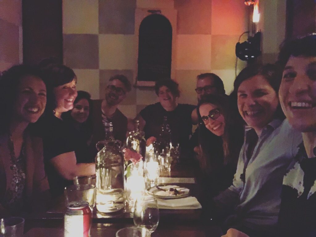 Christa and a group of friends around a restaurant table